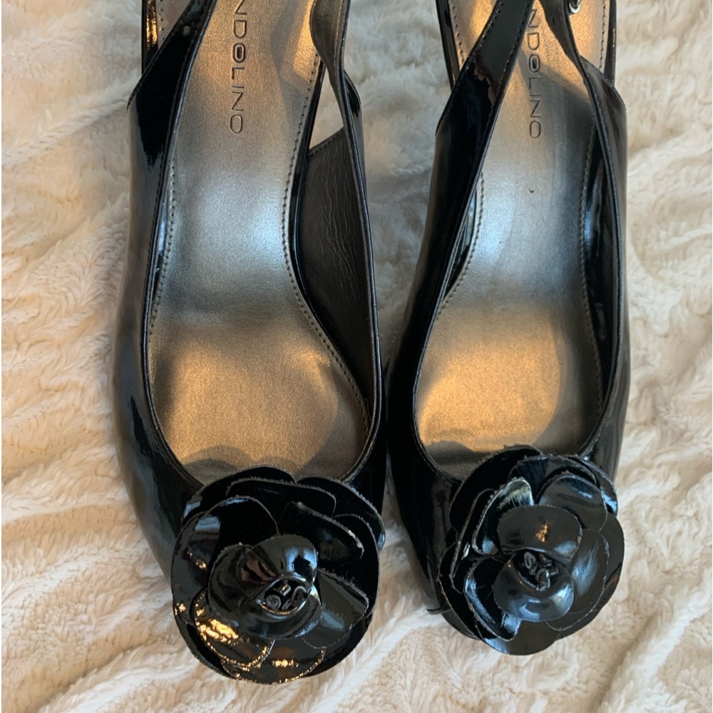 Bandalino black heels with strap, and decorative flower attached.